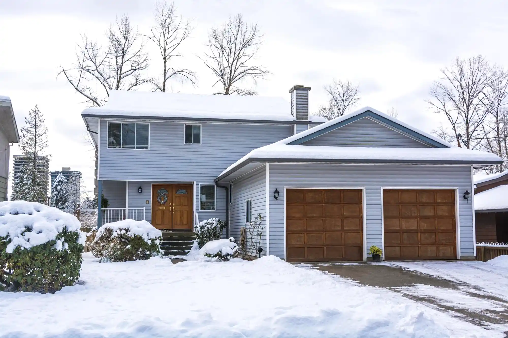 house in new york with solar panels covered in snow in winter