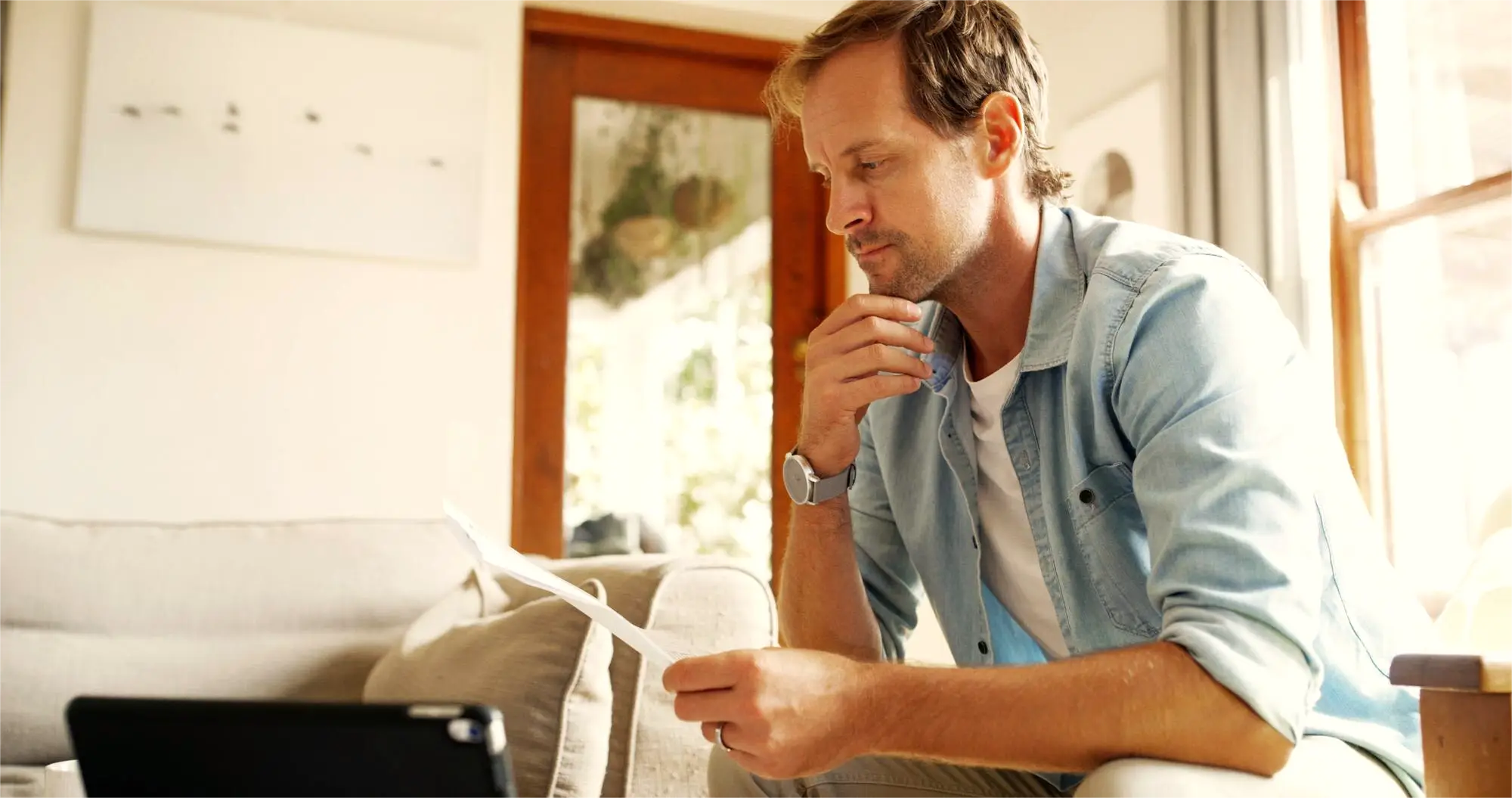 ny homeowner looking at his electric bill