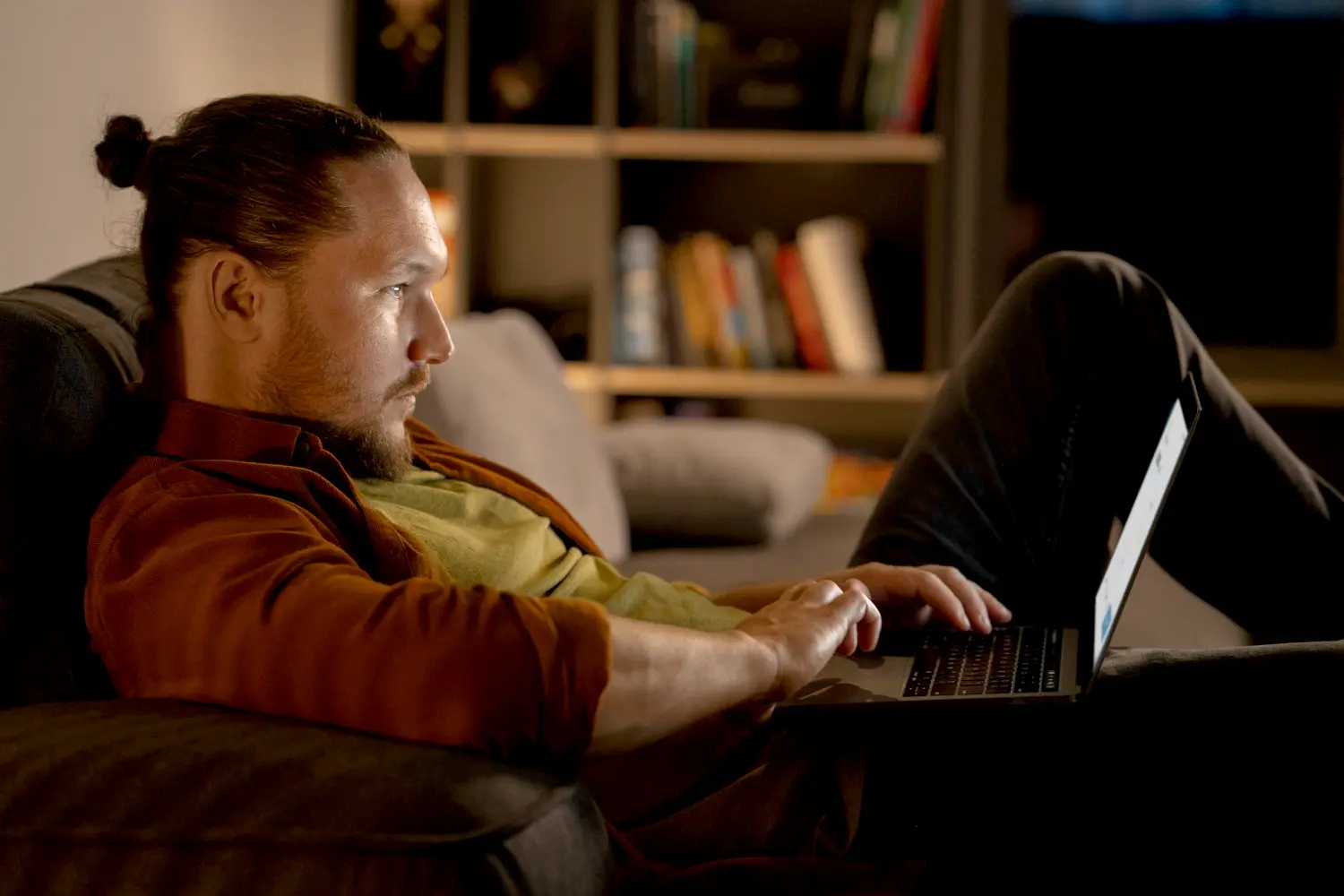 ny homeowner looking dissapointed uses laptop to check his electricity bills