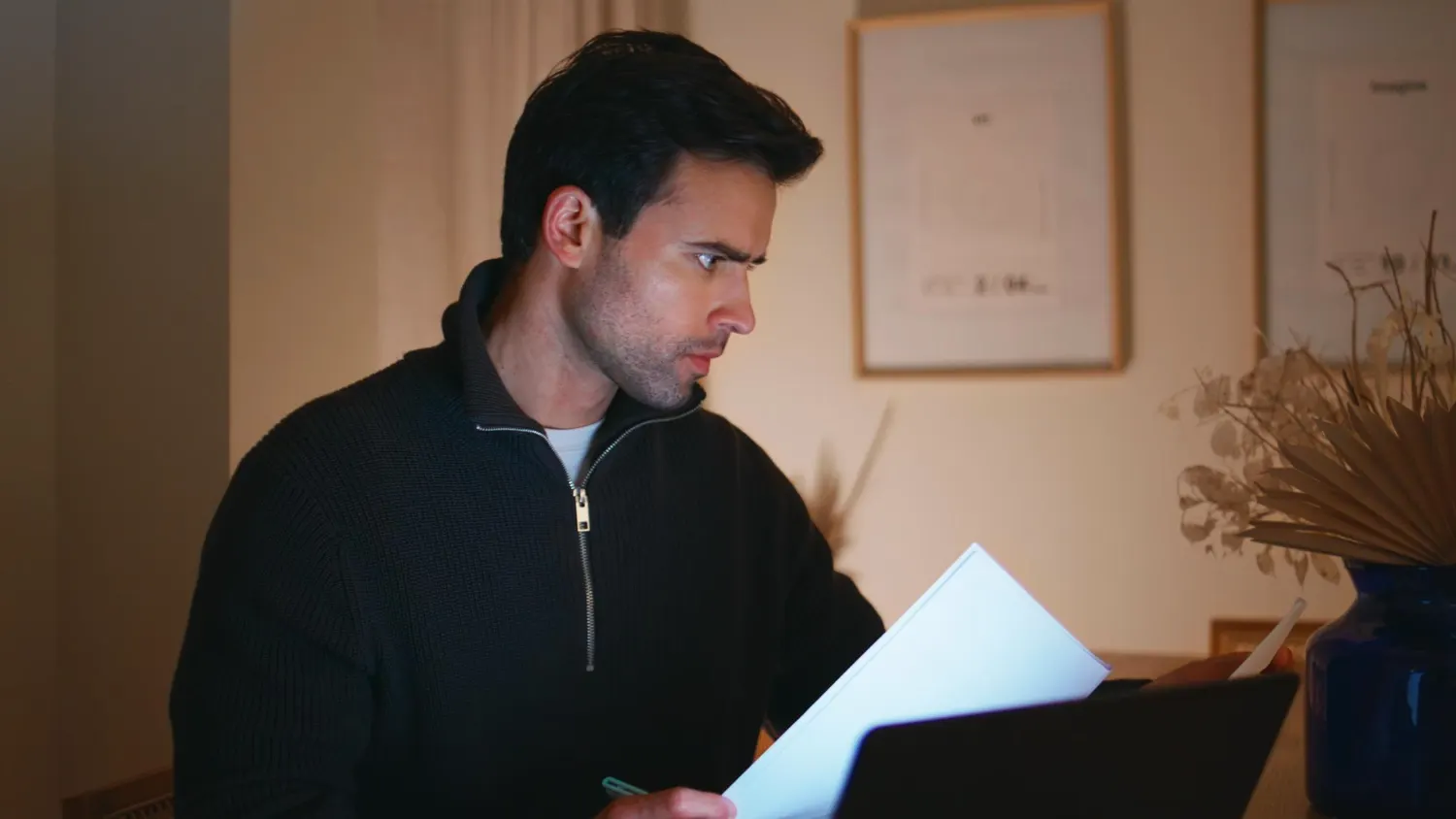 new york homewoner looking through home documents bills in the evening