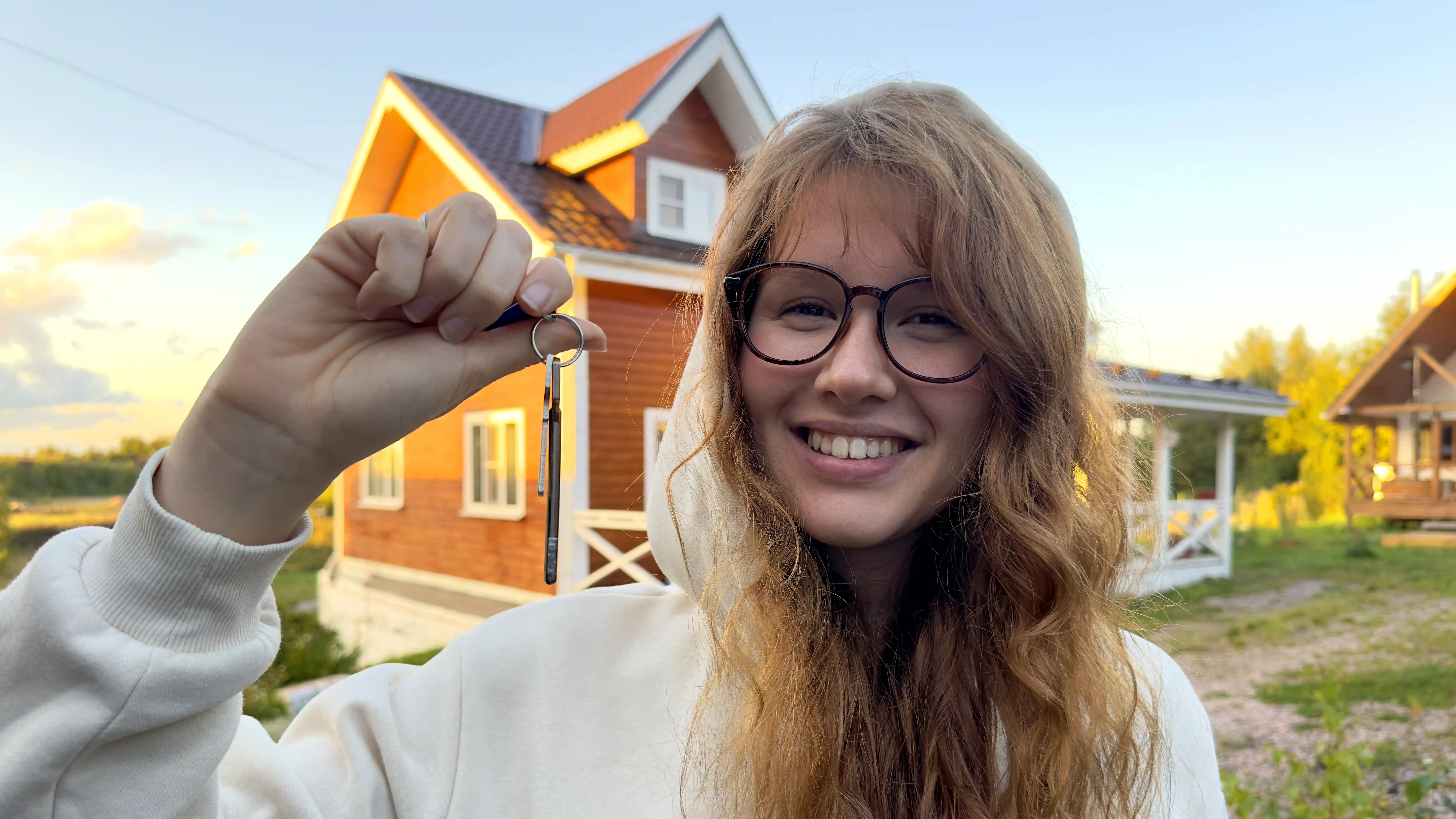 happy homeowner keeping the key and smiling