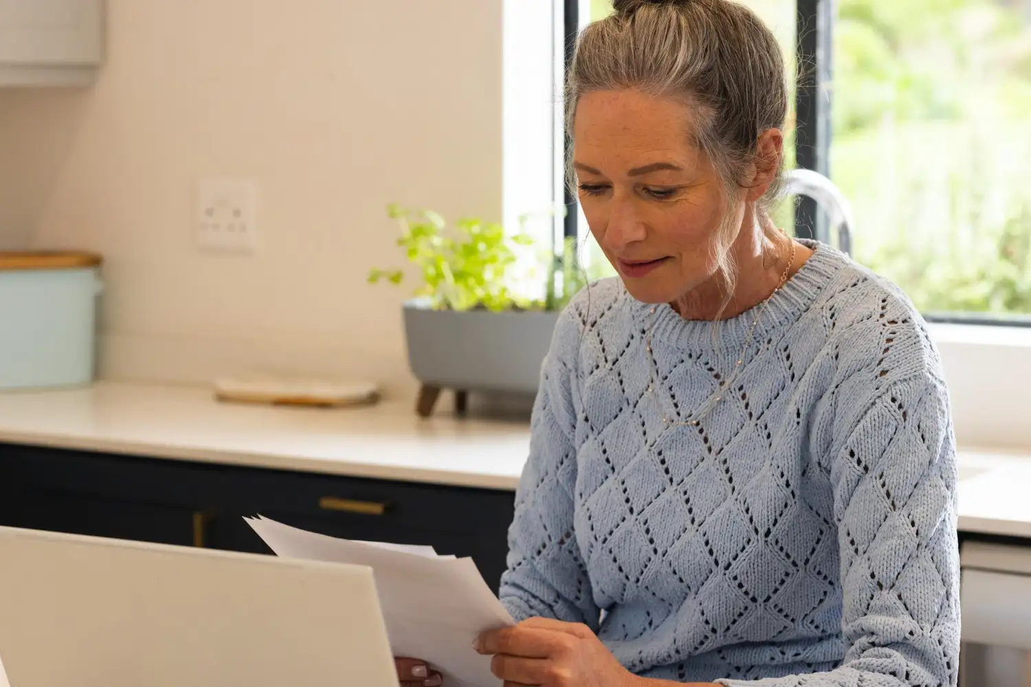 woman homeowner looking at her electric bill in ny